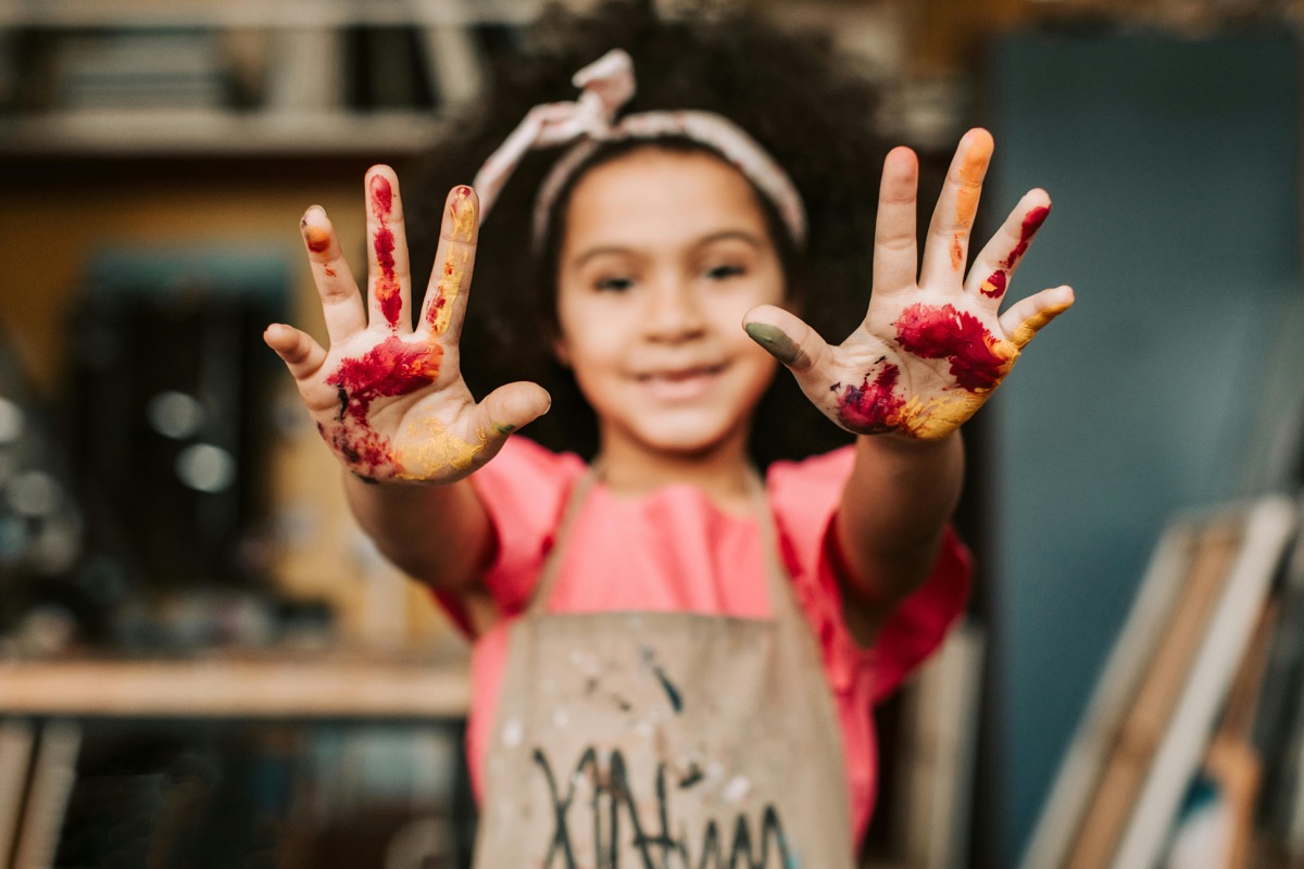 Child painting at an indoor kids workshop