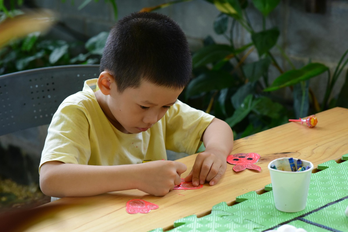 Child doing a hands-on craft or building activity